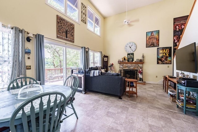 64 Porcupine Point Rd, Tolland, MA 01034 - dining room featuring a towering ceiling, a fireplace, baseboards, and ceiling fan