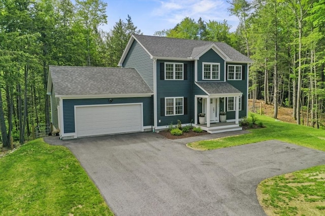 1076 King Phillip Trl, Templeton, MA 01468 - colonial-style house featuring driveway, an attached garage, a porch, a front yard, and a shingled roof