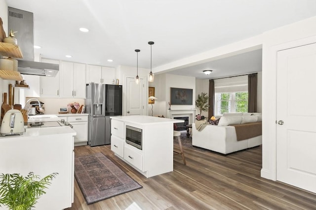 1076 King Phillip Trl, Templeton, MA 01468 - kitchen with appliances with stainless steel finishes, a breakfast bar, light countertops, white cabinets, and pendant lighting