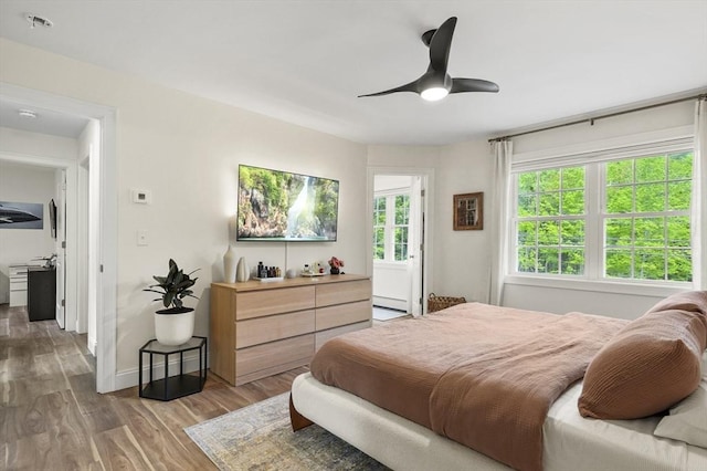1076 King Phillip Trl, Templeton, MA 01468 - bedroom with light wood finished floors, ceiling fan, baseboards, and a baseboard radiator