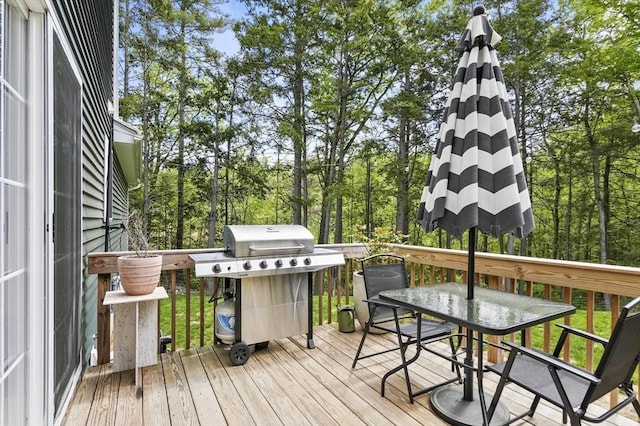 1076 King Phillip Trl, Templeton, MA 01468 - wooden deck featuring area for grilling, outdoor dining area, and view of wooded area