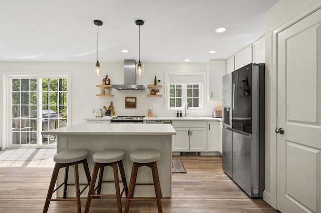 1076 King Phillip Trl, Templeton, MA 01468 - kitchen featuring stainless steel appliances, wall chimney exhaust hood, a kitchen bar, a sink, and light countertops