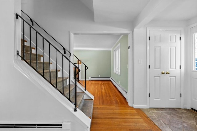 43 Grove Hill Park, Newton, MA 02460 - foyer entrance with baseboard heating, a baseboard heating unit, stairs, and wood finished floors