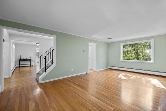 43 Grove Hill Park, Newton, MA 02460 - unfurnished living room featuring a baseboard heating unit, stairs, wood finished floors, baseboards, and ornamental molding