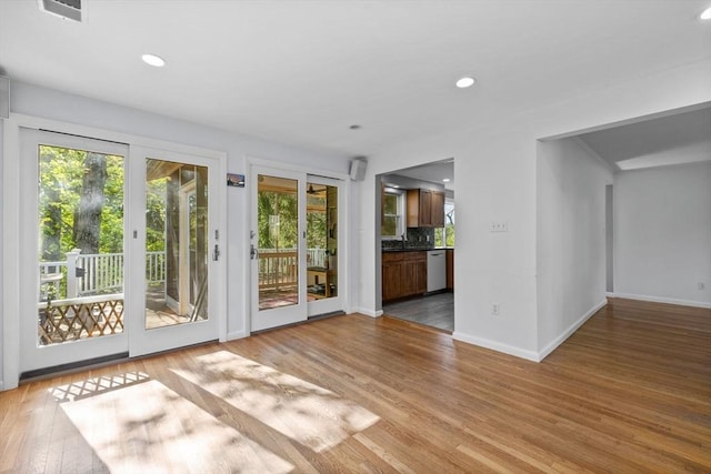 43 Grove Hill Park, Newton, MA 02460 - unfurnished living room with healthy amount of natural light, light wood-style floors, baseboards, and recessed lighting