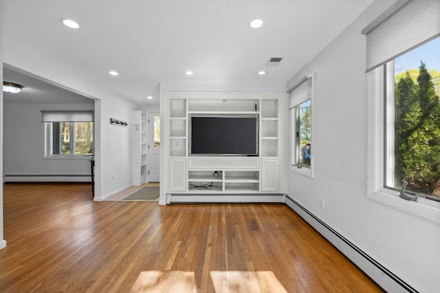 43 Grove Hill Park, Newton, MA 02460 - unfurnished living room featuring baseboard heating, wood finished floors, recessed lighting, and baseboards