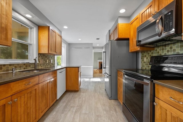 43 Grove Hill Park, Newton, MA 02460 - kitchen featuring stainless steel appliances, a sink, light wood-style flooring, brown cabinets, and recessed lighting