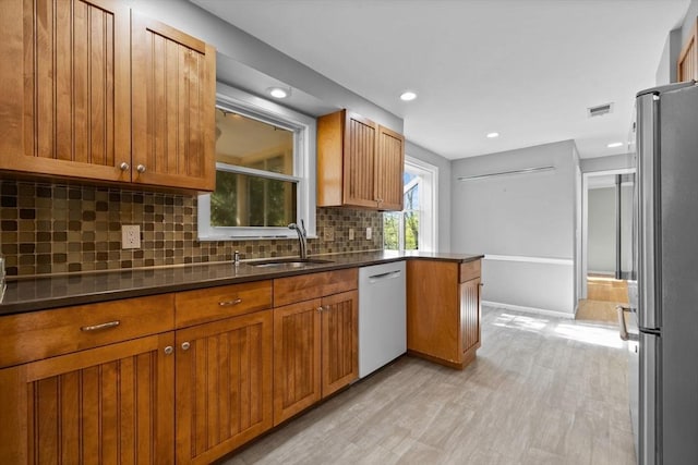 43 Grove Hill Park, Newton, MA 02460 - kitchen with freestanding refrigerator, white dishwasher, backsplash, brown cabinets, and recessed lighting