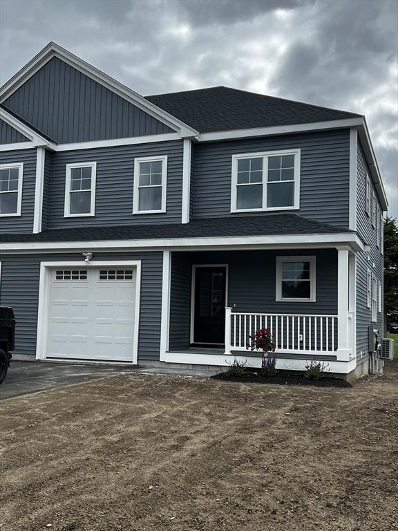 7 Ariana Cir Unit 7, Milford, MA 01757 - view of front facade with a porch, a garage, driveway, central AC unit, and a shingled roof