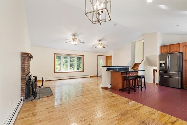 728 River St, Winchendon, MA 01475 - kitchen featuring stainless steel fridge, baseboard heating, a baseboard radiator, lofted ceiling, and open floor plan
