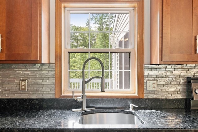 728 River St, Winchendon, MA 01475 - kitchen featuring a sink, backsplash, brown cabinetry, and plenty of natural light