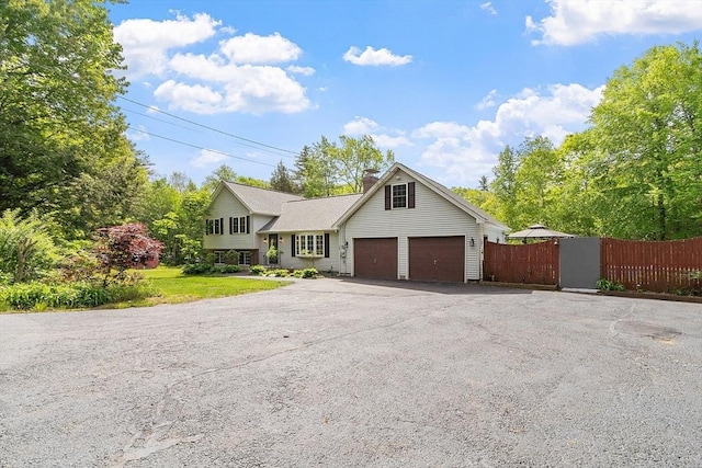 728 River St, Winchendon, MA 01475 - tri-level home with a chimney, asphalt driveway, and a gate
