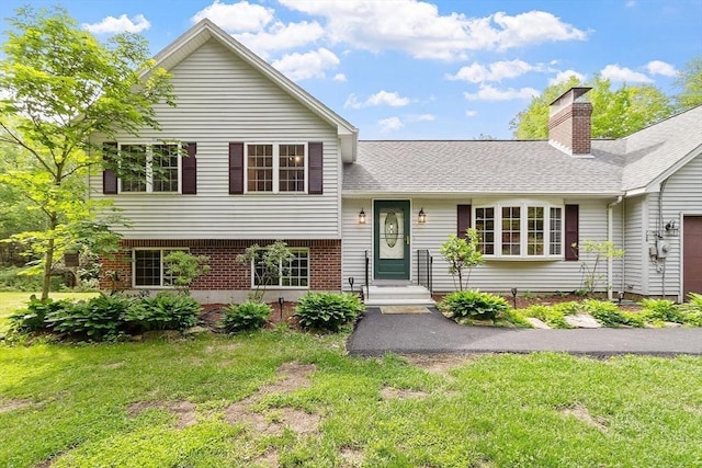 728 River St, Winchendon, MA 01475 - view of front of property featuring a front lawn, a chimney, brick siding, a garage, and roof with shingles