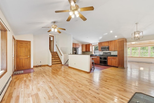 728 River St, Winchendon, MA 01475 - living room featuring baseboard heating, vaulted ceiling, light wood-style flooring, a chandelier, and stairway