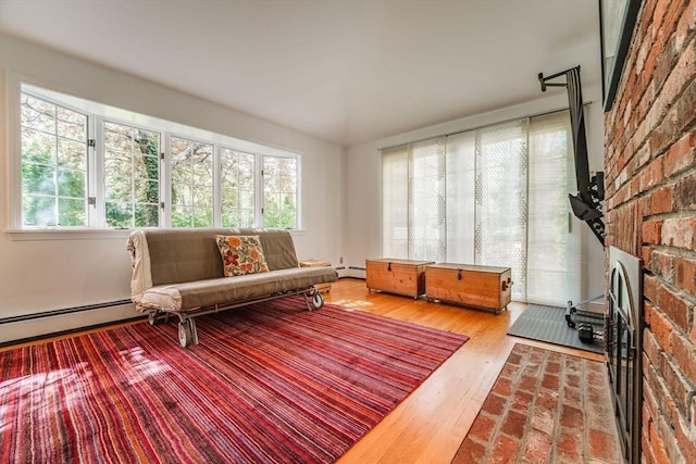 living room featuring wood finished floors and baseboard heating