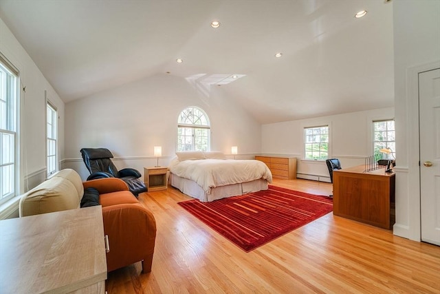 bedroom with wood finished floors, vaulted ceiling, multiple windows, and baseboard heating