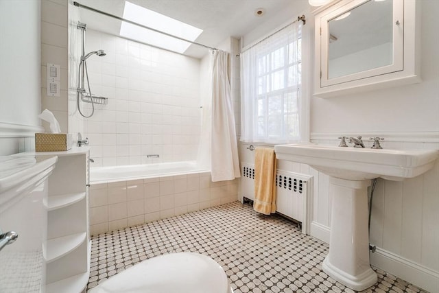 bathroom with tile patterned floors and tiled shower / bath combo
