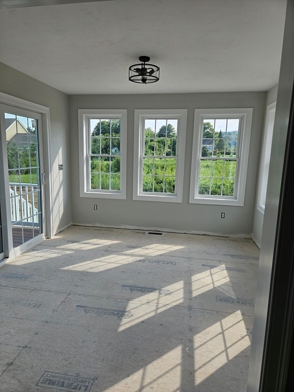 unfurnished room featuring plenty of natural light