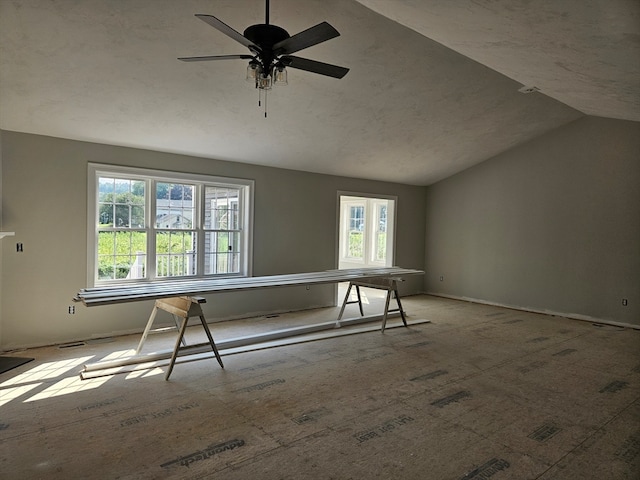 spare room featuring vaulted ceiling and ceiling fan