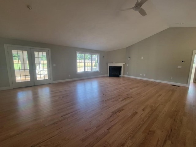 unfurnished living room with wood-type flooring, lofted ceiling, and ceiling fan