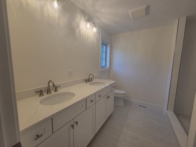 bathroom featuring walk in shower, vanity, and toilet