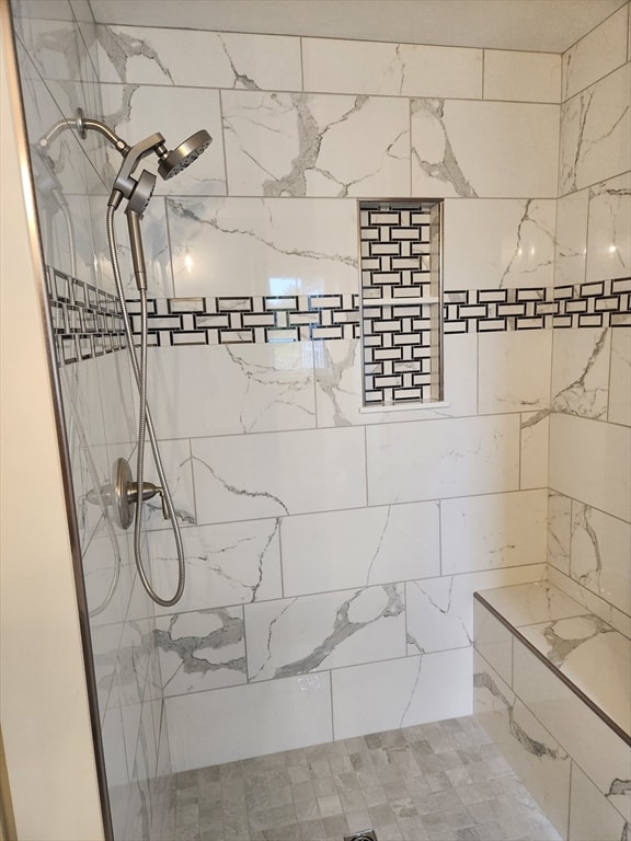 bathroom with tiled shower