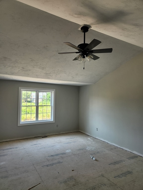 unfurnished room featuring vaulted ceiling and ceiling fan