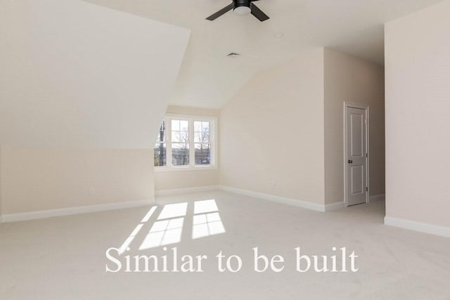 unfurnished room featuring baseboards, carpet floors, lofted ceiling, and ceiling fan