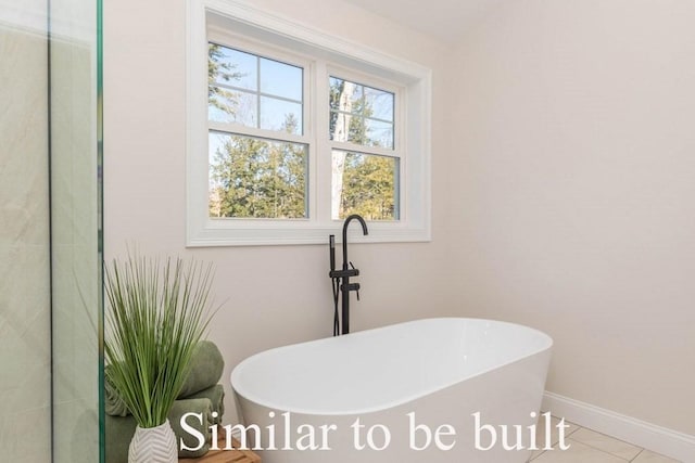 full bathroom featuring a soaking tub and baseboards