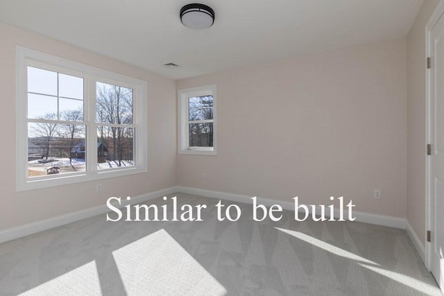 empty room with visible vents, baseboards, and carpet