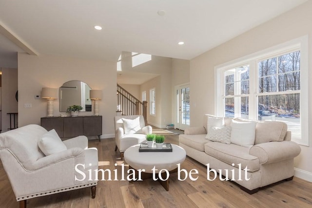 living room featuring recessed lighting, stairs, baseboards, and wood finished floors