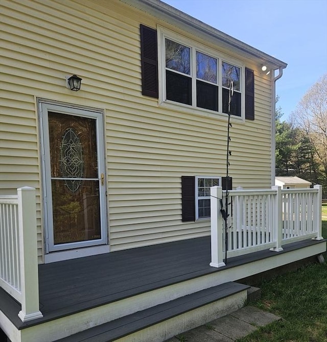 view of side of home with a wooden deck