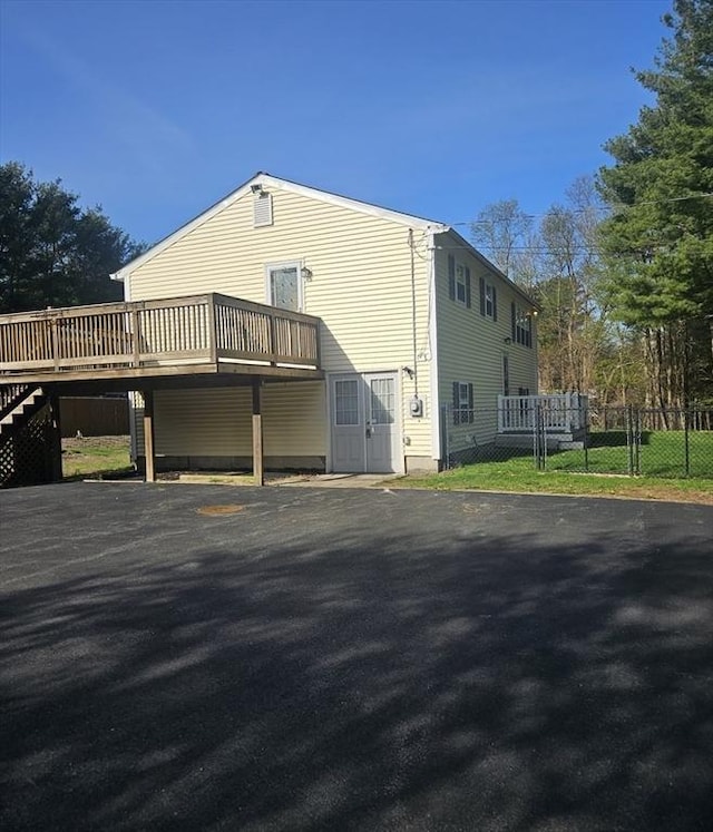 exterior space with a deck and fence
