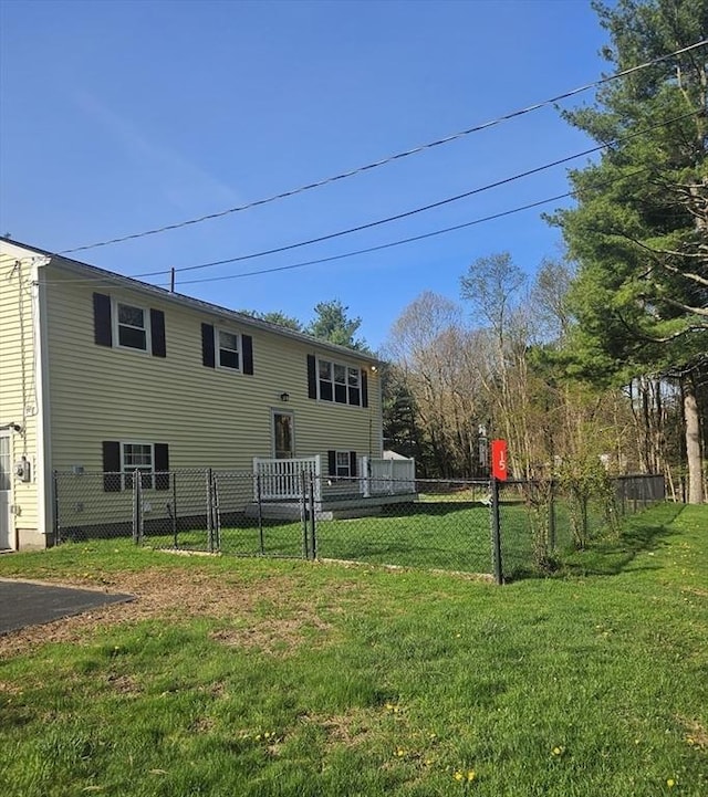 back of property with fence and a yard