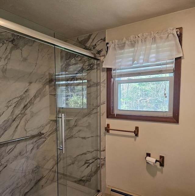 bathroom featuring a marble finish shower