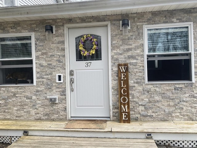 entrance to property with stone siding