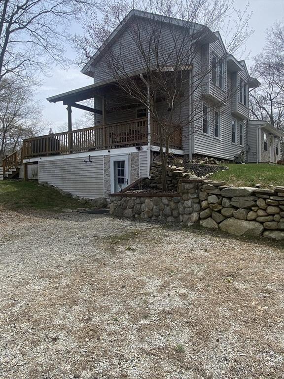 view of side of home with a wooden deck