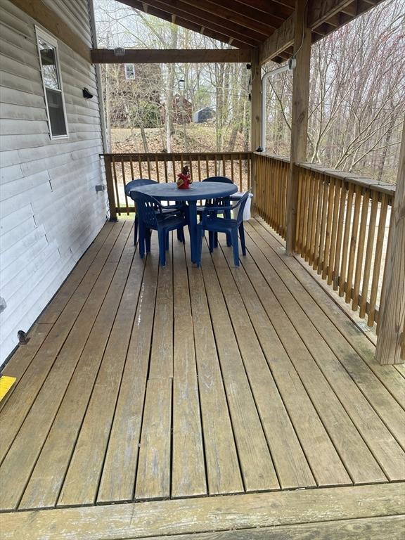 wooden terrace featuring outdoor dining area