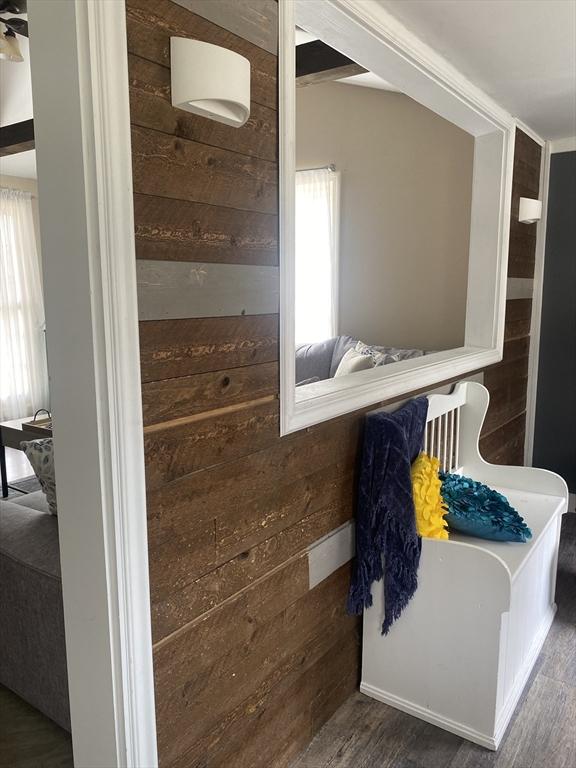 bathroom featuring wood walls and wood finished floors