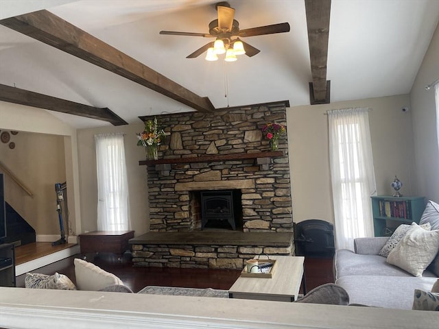living room with vaulted ceiling with beams and a ceiling fan