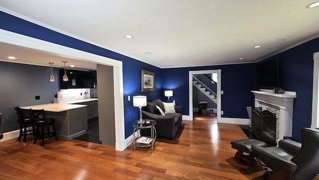 9 Venner Rd, Arlington, MA 02476 - living room with wood finished floors, stairs, ornamental molding, baseboards, and recessed lighting