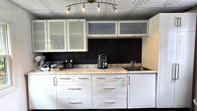 9 Venner Rd, Arlington, MA 02476 - kitchen featuring a sink, an ornate ceiling, glass insert cabinets, and white cabinets