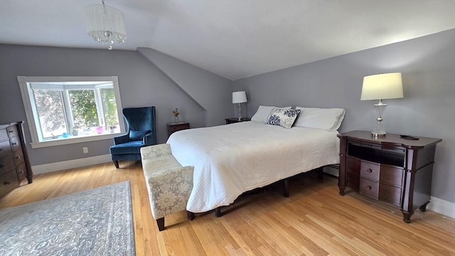 9 Venner Rd, Arlington, MA 02476 - bedroom featuring vaulted ceiling, light wood-style floors, baseboards, and a chandelier