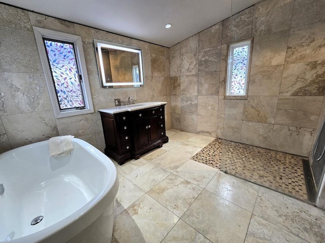 9 Venner Rd, Arlington, MA 02476 - bathroom featuring tile walls, a freestanding bath, vanity, and a walk in shower