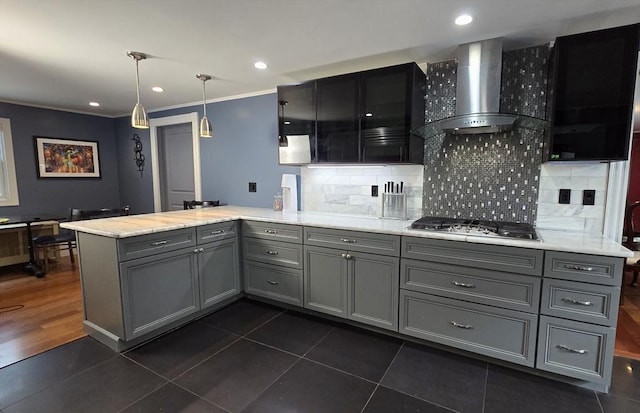 9 Venner Rd, Arlington, MA 02476 - kitchen featuring wall chimney exhaust hood, stainless steel gas cooktop, gray cabinetry, a peninsula, and tasteful backsplash