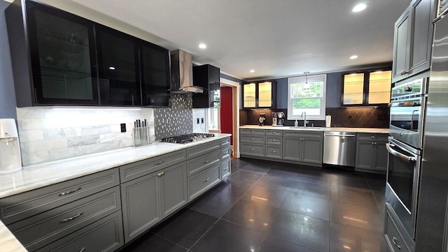 9 Venner Rd, Arlington, MA 02476 - kitchen with stainless steel appliances, wall chimney exhaust hood, gray cabinets, a sink, and light countertops