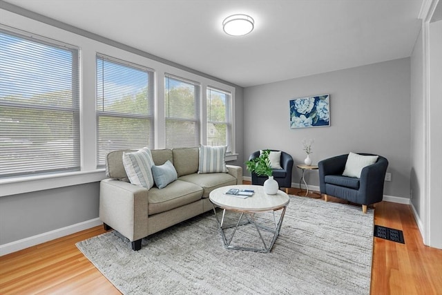 living room with light wood-style flooring and baseboards