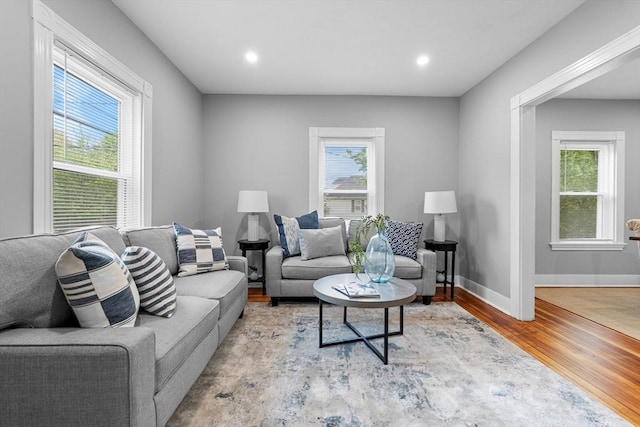 living area with wood finished floors, baseboards, and recessed lighting
