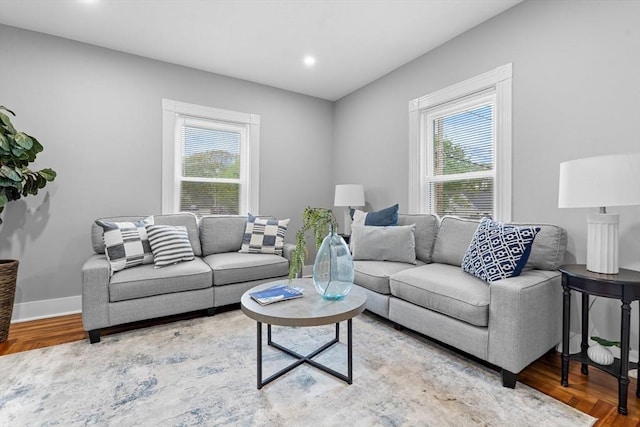 living area featuring healthy amount of natural light, wood finished floors, recessed lighting, and baseboards