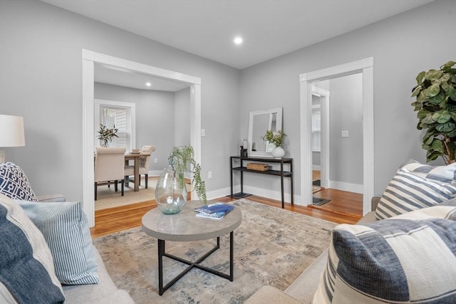 living area featuring wood finished floors, recessed lighting, and baseboards